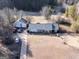 Aerial view of a single-story home with detached garage and cars on a large lot at 2353 Highway 155 N, Mcdonough, GA 30252