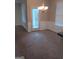 Bright dining area with carpet, a modern chandelier and plenty of natural light at 7069 Littlebrook Way, Douglasville, GA 30134