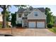 Charming two-story home with a brick-accented two-car garage and well-maintained landscaping at 7069 Littlebrook Way, Douglasville, GA 30134