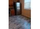 Kitchen features stainless steel refrigerator and modern flooring at 7069 Littlebrook Way, Douglasville, GA 30134