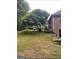 Spacious backyard with mature trees and greenery, offering privacy at 2142 E Atlanta Rd, Stockbridge, GA 30281