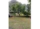 A secluded backyard with mature trees and a view of lush landscaping at 2142 E Atlanta Rd, Stockbridge, GA 30281