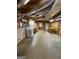 This unfinished basement has cement floors and exposed ceiling, and a kitchenette area with range at 2142 E Atlanta Rd, Stockbridge, GA 30281