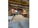 This basement has cement floors, exposed ceiling, and furniture to use for working or hobbies at 2142 E Atlanta Rd, Stockbridge, GA 30281