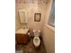 Cozy half bathroom featuring a wooden vanity, neutral tile floors, and marine life decor at 2142 E Atlanta Rd, Stockbridge, GA 30281