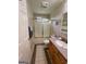 A bathroom with a shower and tub combo and wood cabinets at 2142 E Atlanta Rd, Stockbridge, GA 30281