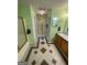 This bathroom features a shower with glass door and a wood vanity with sink and ample counterspace at 2142 E Atlanta Rd, Stockbridge, GA 30281