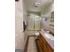 A bathroom with a shower and tub combo and wood cabinets at 2142 E Atlanta Rd, Stockbridge, GA 30281