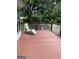 This backyard deck is made of wood and features white wood railings and a relaxing lounge chair at 2142 E Atlanta Rd, Stockbridge, GA 30281