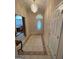 Bright entryway with tiled floor, decorative chandelier, and white front door at 2142 E Atlanta Rd, Stockbridge, GA 30281
