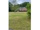 A beautiful one-story brick house with a green lawn and flowering bushes at 2142 E Atlanta Rd, Stockbridge, GA 30281