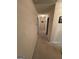 Hallway with carpeted floor and neutral colored walls leading to several rooms at 2142 E Atlanta Rd, Stockbridge, GA 30281