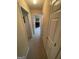 A clean hallway with neutral carpet leadings to other rooms in the home at 2142 E Atlanta Rd, Stockbridge, GA 30281