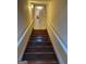 Stairway leads to the lower level with wooden steps and white handrails at 2142 E Atlanta Rd, Stockbridge, GA 30281
