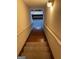 Carpeted steps lead downstairs with a secure handrail, enhancing safety and style at 2142 E Atlanta Rd, Stockbridge, GA 30281