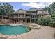Beautiful backyard featuring a pool with a hot tub and a large stone patio at 1385 Gordon Rd, Moreland, GA 30259