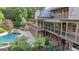 Spacious backyard with a pool, stone patio, and multi-level deck offering serene outdoor living spaces at 1385 Gordon Rd, Moreland, GA 30259