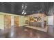 Entertaining bar area with rustic wooden bar, exposed brick, and sliding barn doors at 1385 Gordon Rd, Moreland, GA 30259