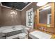 Charming bathroom with a vintage-style tub, elegant fixtures, and a decorative window at 1385 Gordon Rd, Moreland, GA 30259