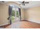 Bright bedroom with hardwood floors, ceiling fan, and large windows leading to balcony at 1385 Gordon Rd, Moreland, GA 30259