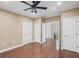 Spacious bedroom features hardwood floors, a ceiling fan, and access to other rooms at 1385 Gordon Rd, Moreland, GA 30259