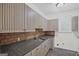 Butler's pantry equipped with granite countertops, custom cabinetry and stainless steel sink at 1385 Gordon Rd, Moreland, GA 30259