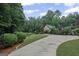Long, paved driveway leading to a home amidst lush greenery and manicured landscaping at 1385 Gordon Rd, Moreland, GA 30259