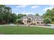 Expansive home with manicured lawn, circular driveway, and beautiful mature landscaping at 1385 Gordon Rd, Moreland, GA 30259