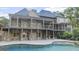 Rear exterior view of a large home with multiple balconies and a pool at 1385 Gordon Rd, Moreland, GA 30259