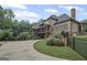 Elegant stone home showcasing a fenced yard and long driveway, surrounded by beautiful landscaping at 1385 Gordon Rd, Moreland, GA 30259