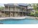 Rear exterior view of a large home with multiple balconies and a pool at 1385 Gordon Rd, Moreland, GA 30259