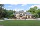 Expansive home with manicured lawn, circular driveway, and beautiful mature landscaping at 1385 Gordon Rd, Moreland, GA 30259