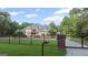 Gated property with a large, beautiful home featuring lush landscaping and a stately presence at 1385 Gordon Rd, Moreland, GA 30259