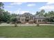 Stately brick home with a manicured lawn, mature landscaping, and classic architectural details at 1385 Gordon Rd, Moreland, GA 30259
