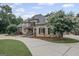 Beautiful brick home featuring a circular driveway, mature landscaping, and stone accents at 1385 Gordon Rd, Moreland, GA 30259