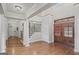 Grand foyer featuring high ceilings, hardwood floors, a staircase with iron railings, and wooden doors at 1385 Gordon Rd, Moreland, GA 30259