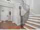 Elegant foyer with wood floors, staircase with decorative wrought iron railings, and natural light at 1385 Gordon Rd, Moreland, GA 30259