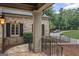 Charming front porch featuring brick and stone architecture, elegant columns, and manicured landscaping at 1385 Gordon Rd, Moreland, GA 30259