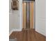 Hallway with wooden floors, a folding door, and a classic design at 1385 Gordon Rd, Moreland, GA 30259