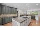 Open kitchen layout with a large island, cooktop, stainless steel appliances, and ample counter space at 1385 Gordon Rd, Moreland, GA 30259
