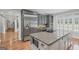 Well-equipped kitchen with stainless steel refrigerator, double ovens, and granite island with microwave at 1385 Gordon Rd, Moreland, GA 30259