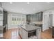 Stylish kitchen featuring stainless steel appliances, a central island, and shuttered windows for natural light at 1385 Gordon Rd, Moreland, GA 30259