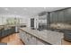 Modern kitchen featuring a large island with cooktop, custom cabinetry, and stainless steel appliances at 1385 Gordon Rd, Moreland, GA 30259