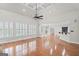 Spacious living room featuring hardwood floors, large windows with plantation shutters and stylish lighting fixtures at 1385 Gordon Rd, Moreland, GA 30259