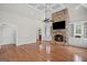 Inviting living room featuring a stone fireplace, built-in cabinets, and hardwood floors at 1385 Gordon Rd, Moreland, GA 30259