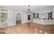 Elegant open floor plan with hardwood flooring seamlessly connecting the living room, kitchen, and sunroom at 1385 Gordon Rd, Moreland, GA 30259