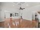 Open-concept living room with hardwood floors and access to the kitchen and bar area at 1385 Gordon Rd, Moreland, GA 30259