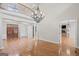 Bright, open living space with hardwood floors, columns, and a view of the fireplace at 1385 Gordon Rd, Moreland, GA 30259