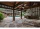 Expansive outdoor area with a covered patio, stone columns, built-in grill and a large swimming pool at 1385 Gordon Rd, Moreland, GA 30259