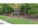 Backyard playground featuring a slide, swing set, climbing net, and lookout tower for endless fun at 1385 Gordon Rd, Moreland, GA 30259